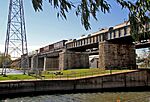 An old railway bridge on stone pillars.