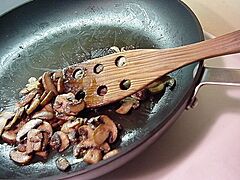 Baby bella mushrooms being sautéed