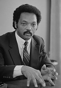 Jesse Jackson, half-length portrait of Jackson seated at a table, July 1, 1983 edit