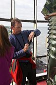 The optic in the lantern, with the shoreline of the Gaspé Peninsula and the St. Lawrence River in the distance.