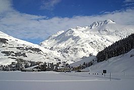 Andermatt looking east towards the Oberalp Pass with cable car (to Gemsstock) bottom station in front and Rossbodenstock (2836m) in the back (8 Feb 2003)