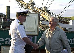 US Navy 050626-N-9565D-005 Capt. Michael Gordon, receives from Chairman of Whitehaven Harbour Commissioners, Gordon Thomson, a copy of the local newspaper from April 1778