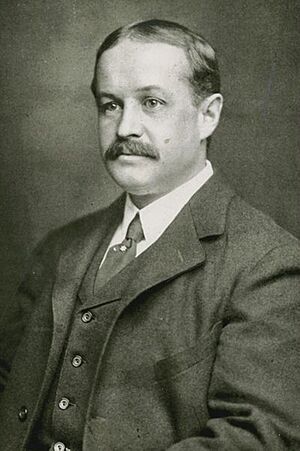 Thayer in middle age;  light skin, dark hair, moustache, wearing a business suit