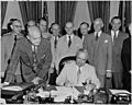 Photograph of President Truman at his desk in the Oval Office, signing the National Security Act Amendments of 1949... - NARA - 200168