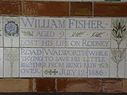 A tablet formed of five tiles of varying sizes, bordered by yellow and blue flowers in an art nouveau style