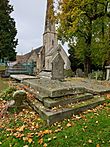 Photograph of the grave of Louisa Cooke, née Hardy, with St Peter's Church, Leckhampton, shown in the background