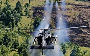 MH-60M DAP firing 2.75 inch rockets at a test ground