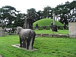 Stone statues and other monuments around a royal tomb