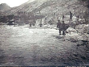 Small boat shooting the rapids on One Mile River between Bennett Lake and Lindeman Lake, British Columbia, 1897 (LAROCHE 301)