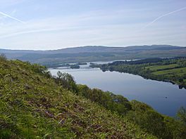 A lake surrounded by hills and trees