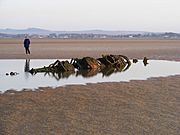 Wreck of the same XT-Craft with a person in view showing scale