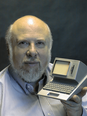 Jef Raskin holds a model of the Canon Cat.