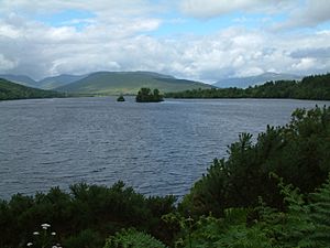 A lake surrounded by trees and hills