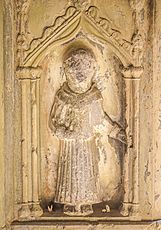 Statue in Cloisters said to have the cure for toothache. You can see teeth as votive offerings at the foot of the statue!