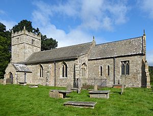 A stone church seen from the south with a battlemented tower on the left