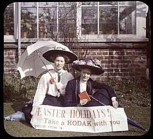 Two women holding a sign that readsEaster Holidays! Take a Kodak with you Prices from 5- (3333256161)
