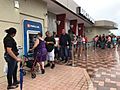 Residents of Ponce, Puerto Rico, line up at an ATM in hopes of getting some cash. More than a week after Hurricane Maria struck, residents are waiting in long lines to withdraw money and for gasoline