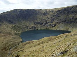 A lake in the hollow of a mountain top