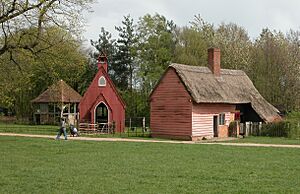 a cottage and a corrugated iron chapel in a field