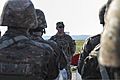 Armenian army Capt. Avetisyan Slavik, a platoon leader, gives a safety briefing to his troops before loading onto a U.S. Army UH-60 Black Hawk helicopter during a training exercise March 12, 2014, at Camp 140312-A-QK348-046