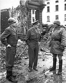 General Omar Bradley, General Dwight Eisenhower, and General George Patton, all graduates of West Point, survey war damage in Bastogne, Belgium. 1944-1945