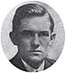 Round portrait of a young man dressed in a suit and with neatly combed hair.