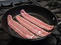 Turkey bacon cooking in skillet.jpg