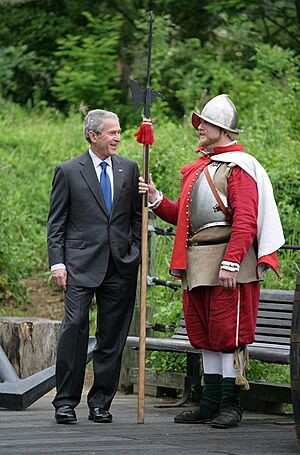 President George W. Bush stands with an actor in period garb during a tour of the Jamestown Settlement