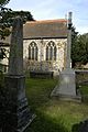 Side view of the chancel, an obelisk and the war memorial of Church of S.S. Peter & Paul, Harlington, 2014