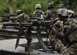 US Navy 070825-N-9769P-317 A Special Warfare Combatant-craft crewman (SWCC) mans his GAU-17 minigun during live-fire patrol training along the Salt River in northern Kentucky