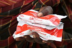 18-month-old James and his mother Margaret, pictured with a supply of sachets og Plumpy Nut, a Ready to Use Therapeutic Food used to treat acute maluntrition, Turkana County, northern Kenya, 28 March 2017 (33140342933).jpg