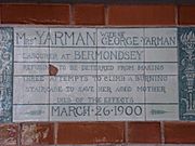 A tablet formed of six standard sized tiles, bordered by green flowers in the style of the Arts and Crafts movement