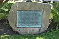 Stone plaque marking the site of the first public school in America