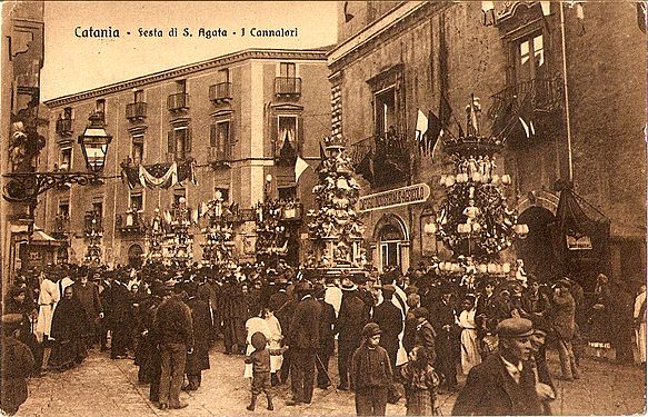 A sepia-toned black and white photograph of a crowd of people.