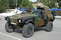 Front view of a VBL with a French-style camouflage. The older Greek flag is painted on its license plate.