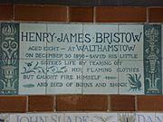 A tablet formed of six standard sized tiles, bordered by green flowers in the style of the Arts and Crafts movement