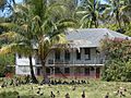 Starr 080531-4733 Midway Island Cable station building (nb 643) in May 2008 with cocos nucifera