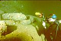 Diver photographing artillery shells in hold of the Yamagiri Maru wreck, Truk Lagoon, Micronesia