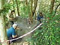 GT staff and volunteers smoothing surface of mud sofa