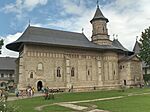 A stone church with tourists around