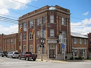 An image of a two-story beige brick neoclassical building with a colonnaded portico, and topped by a dome