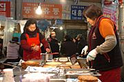 Women pan-frying Korean pancakes-01