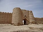 Ruins of buildings near a lake.