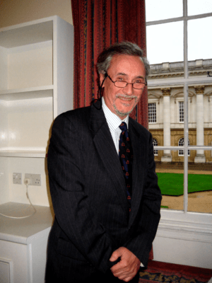 Greetham leaning on windowsill