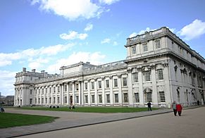 A long white building with very regular pilasters and rectangular windows.