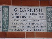 A tablet formed of six standard sized tiles, bordered by green flowers in the style of the Arts and Crafts movement