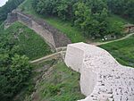 Fortress walls in a forest on a hill