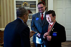 Barack Obama gives a Presidential coin to Nick Wetzel