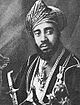 A black-and-white photograph of a man with a dark beard wearing a turban, a dark jacket, a white shirt, and several medals and looking to the right of the viewer