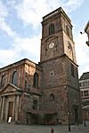 Part of a Neoclassical church showing the west end of the nave, and the tower with its balustraded parapet